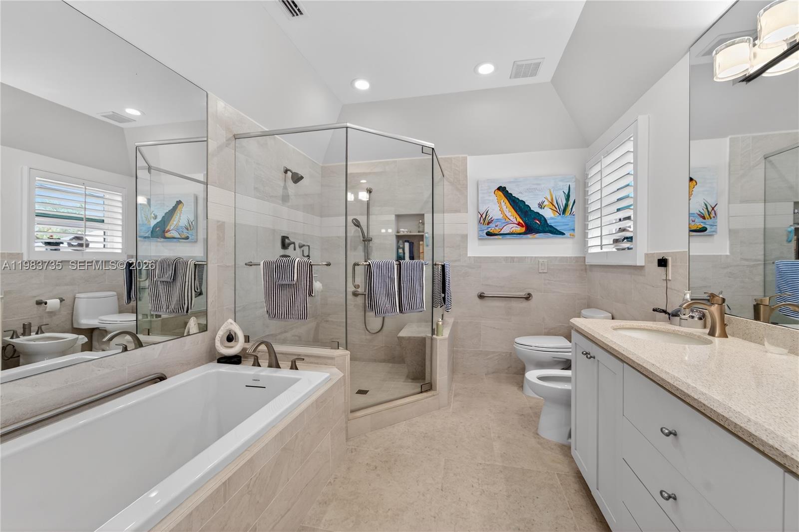 851 Saturn Street, Unit D Jupiter, FL 33477 - Photo 23 of 60 a bathroom with a double vanity sink toilet and shower