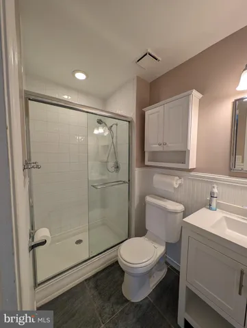 a bathroom with a toilet sink and shower