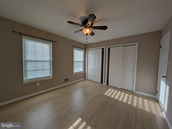 a view of a livingroom with a ceiling fan and window