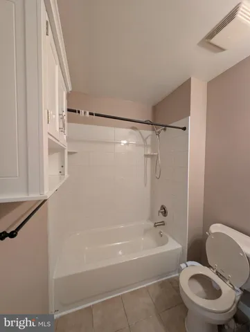 a bathroom with a toilet and a bathtub
