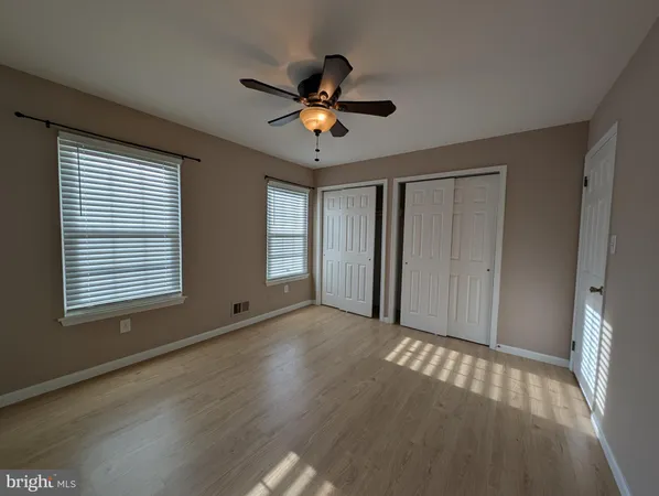 a view of a livingroom with a ceiling fan and window