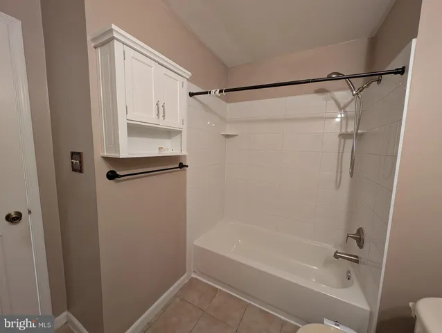 a bathroom with a shower and a bath tub
