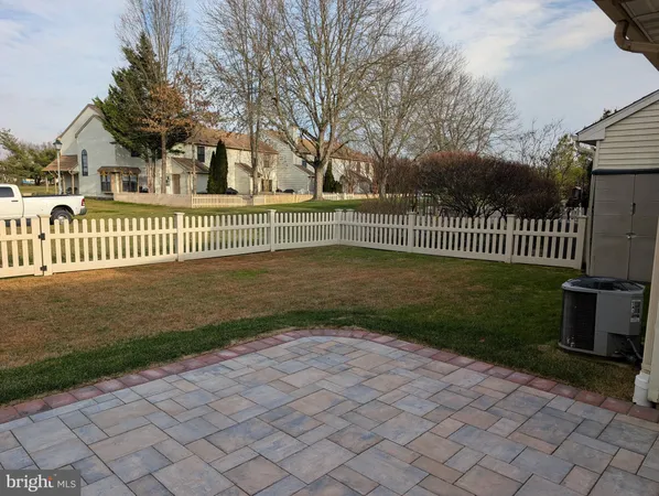 a view of a park with a fence and trees