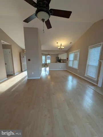 a view of a livingroom with furniture and chandelier fan