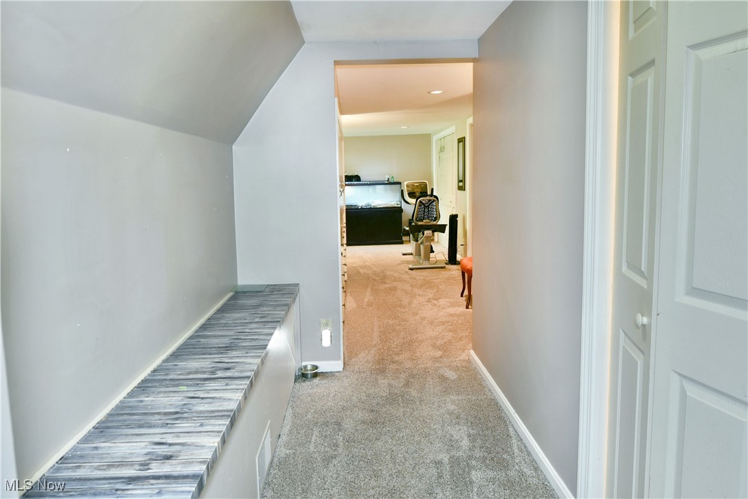 519 Butler Road Northeast Warren, OH 44483 - Photo 37 of 50 Hallway with lofted ceiling and light colored carpet