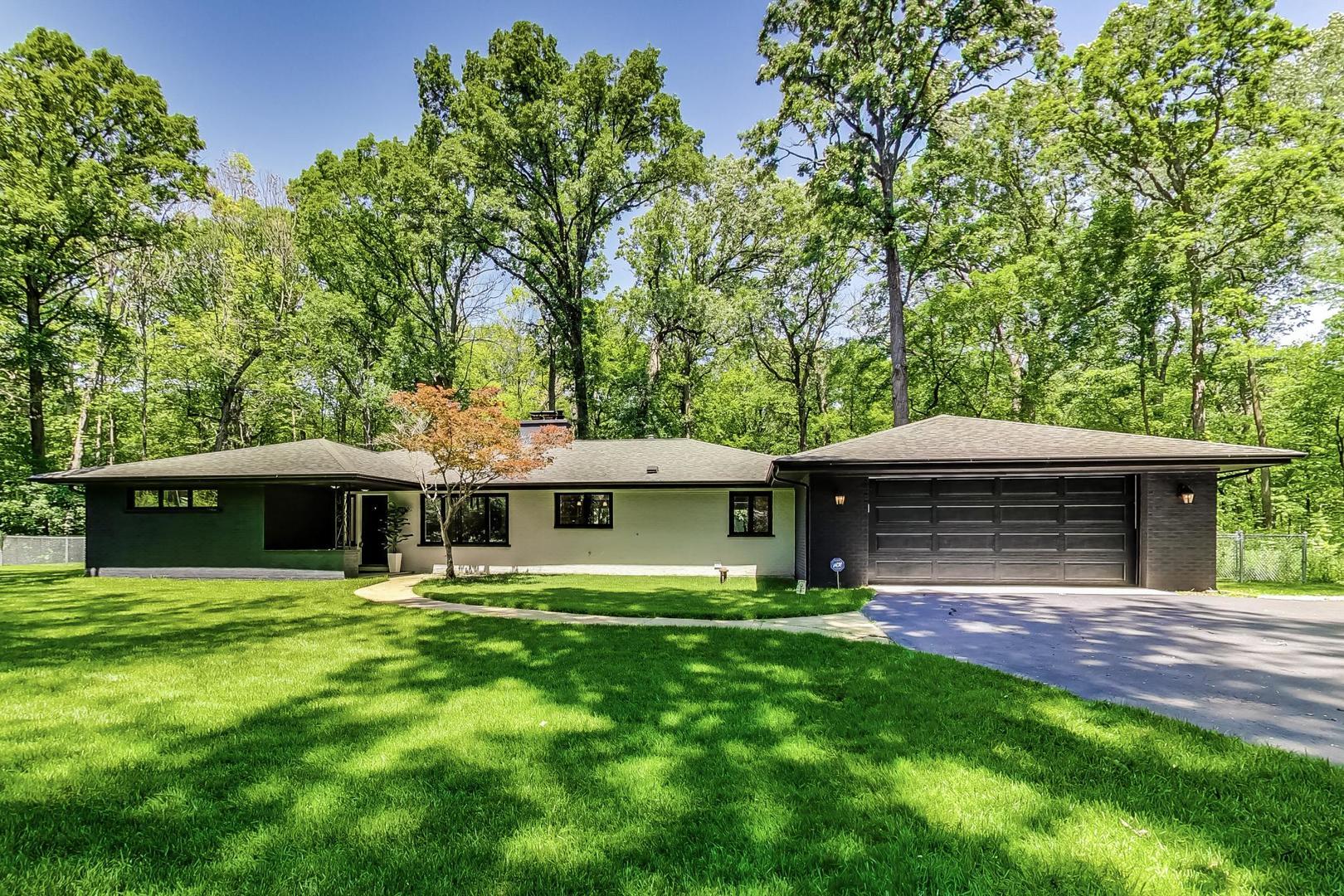 a view of a house with a yard and sitting area