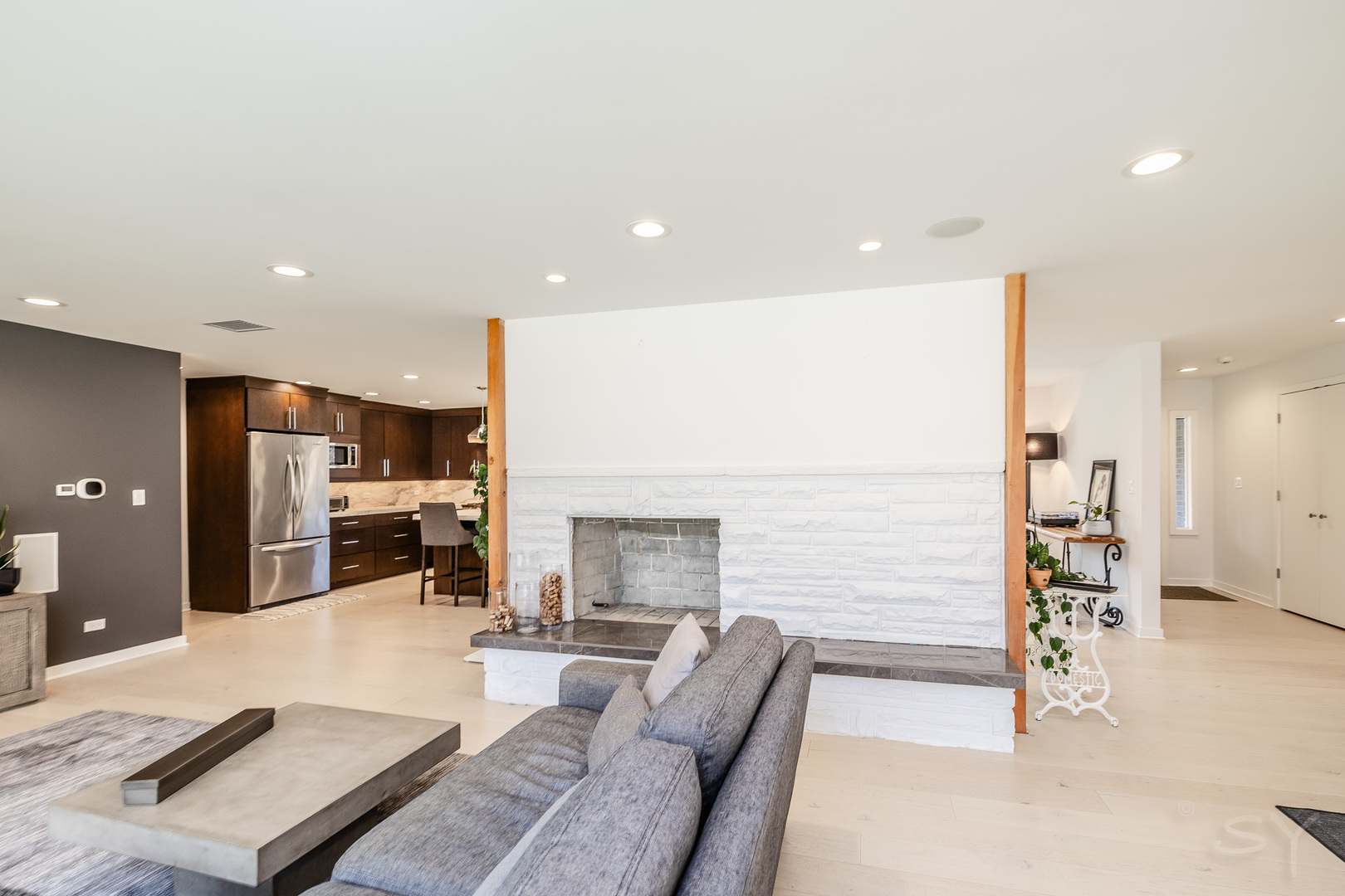 3060 Orange Brace Road Riverwoods, IL 60015 - Photo 16 of 36 a living room with couches and kitchen view with wooden floor