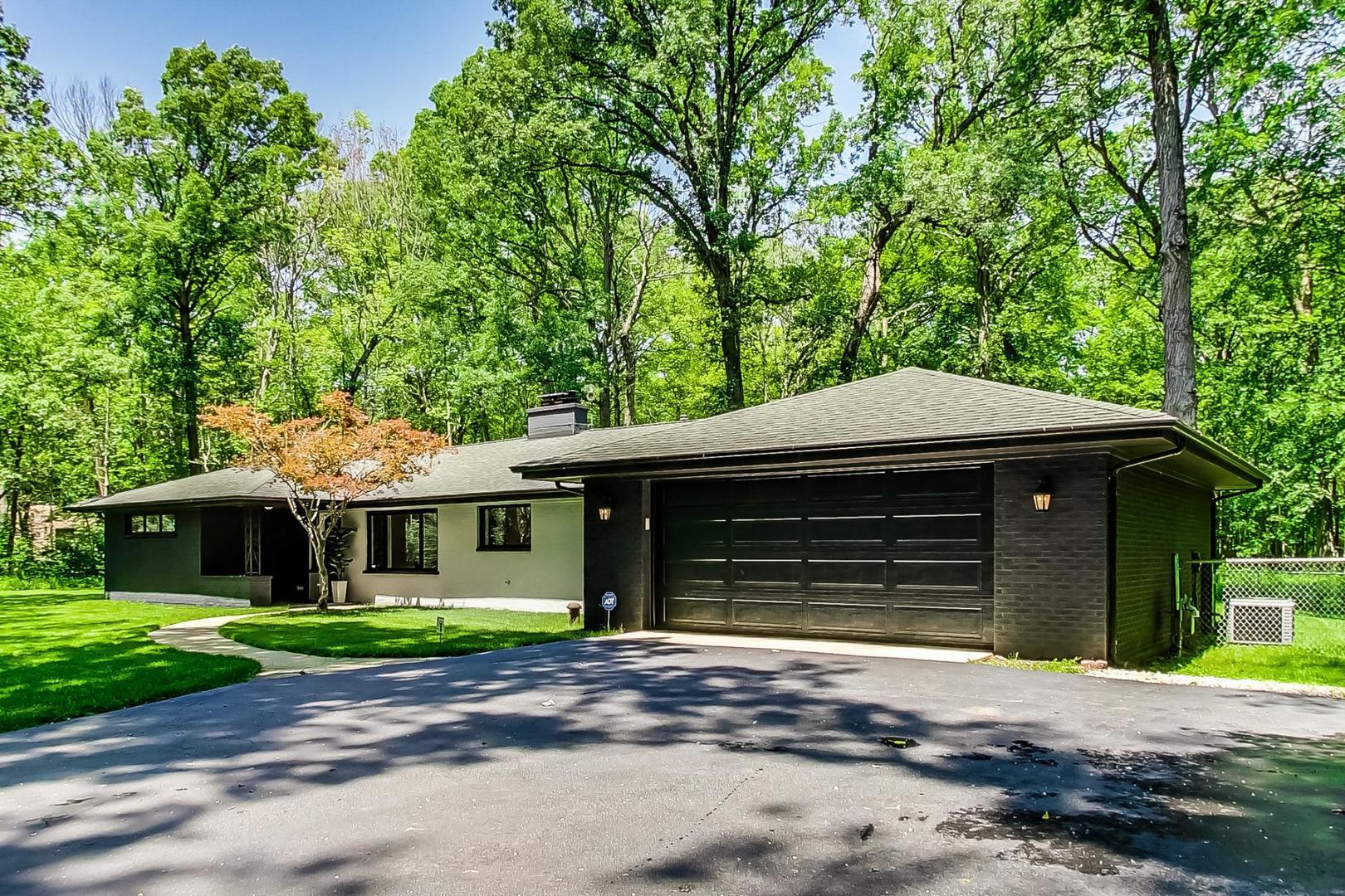 3060 Orange Brace Road Riverwoods, IL 60015 - Photo 2 of 36 a front view of a house with a yard and garage