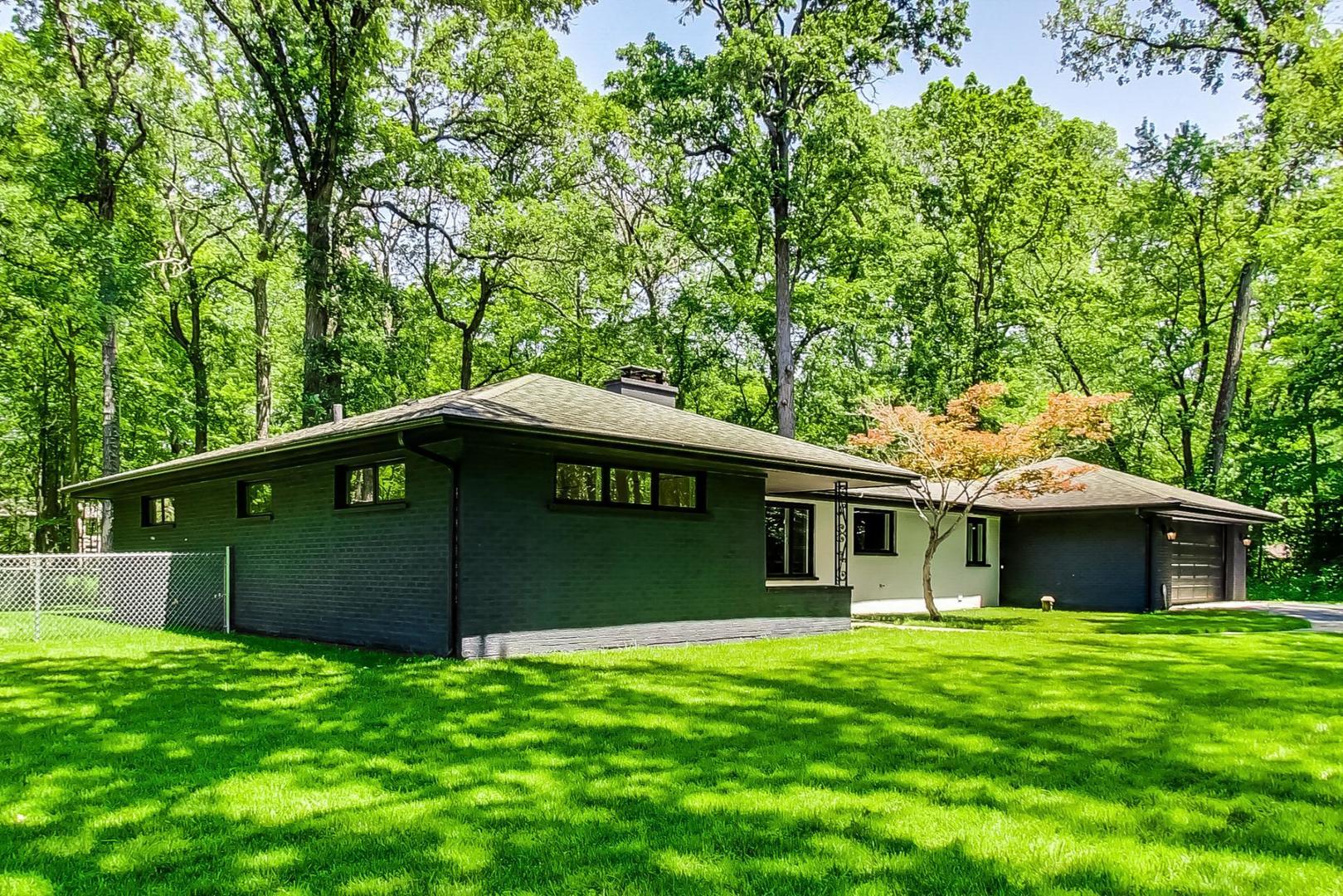 3060 Orange Brace Road Riverwoods, IL 60015 - Photo 3 of 36 a front view of a house with a garden