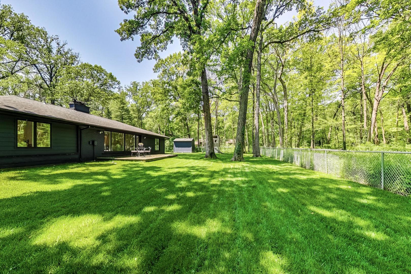 3060 Orange Brace Road Riverwoods, IL 60015 - Photo 35 of 36 a backyard of a house with table and chairs