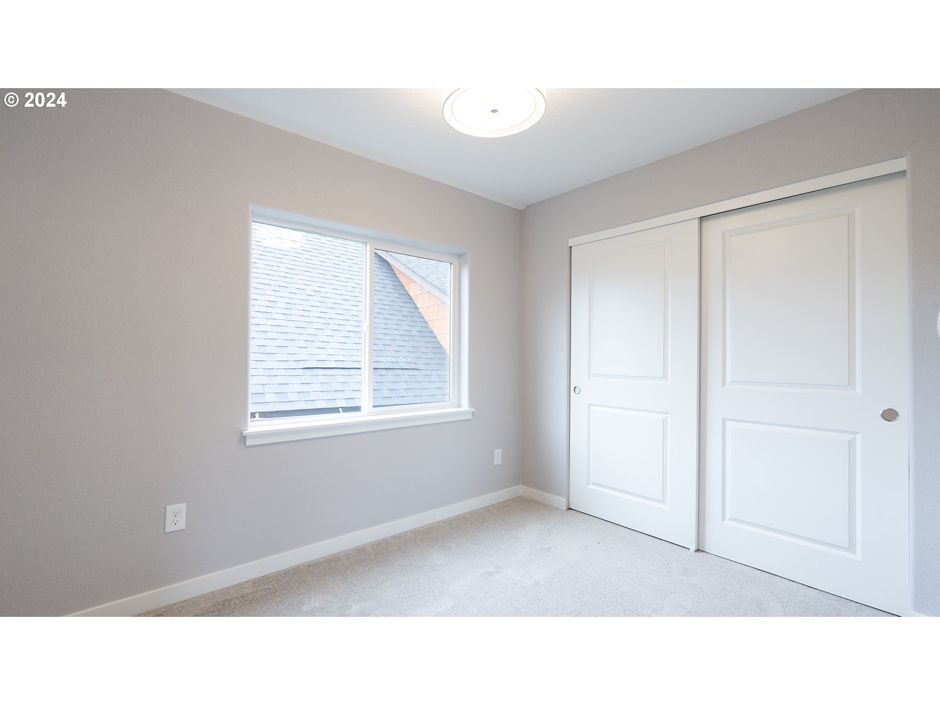 6921 Southeast Pardee Street, Unit A Portland, OR 97206 - Photo 13 of 16 a open living room with a window and a wooden floor