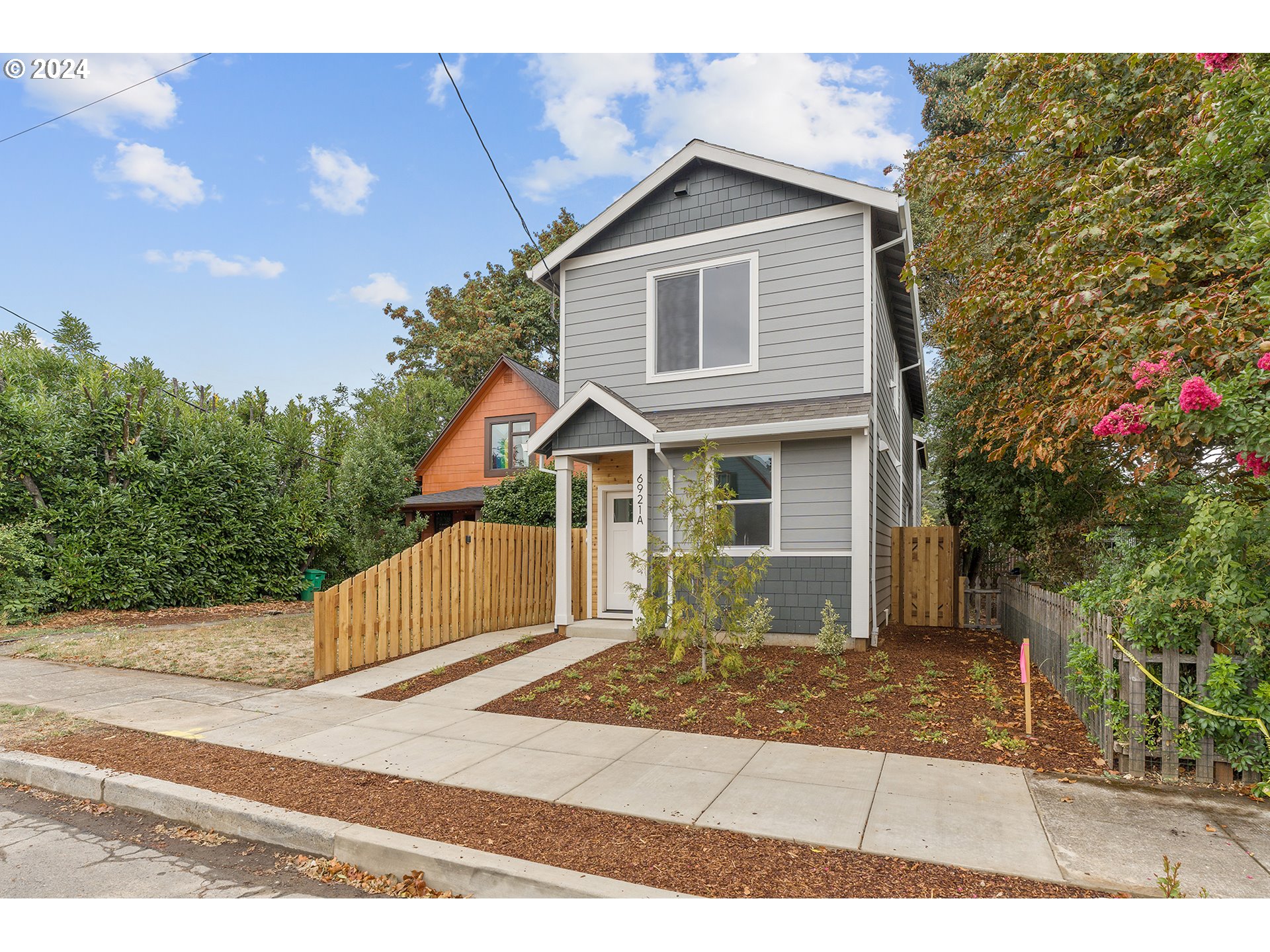 6921 Southeast Pardee Street, Unit A Portland, OR 97206 - Photo 2 of 16 a front view of a house with a yard