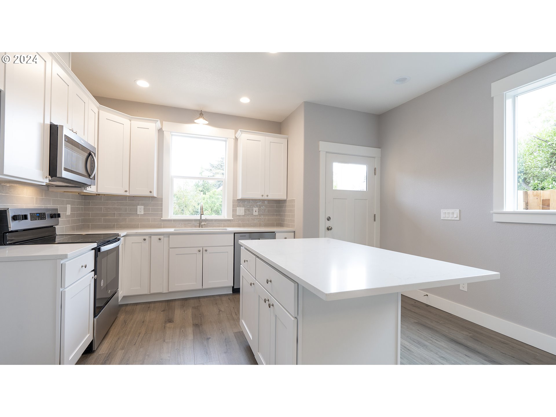 6921 Southeast Pardee Street, Unit A Portland, OR 97206 - Photo 6 of 16 a kitchen with a sink microwave and cabinets