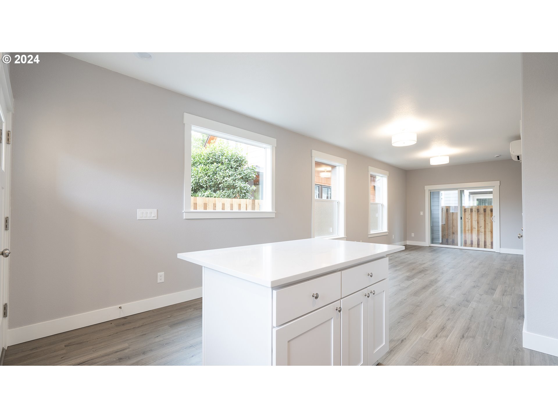6921 Southeast Pardee Street, Unit A Portland, OR 97206 - Photo 7 of 16 a open kitchen with windows and sink