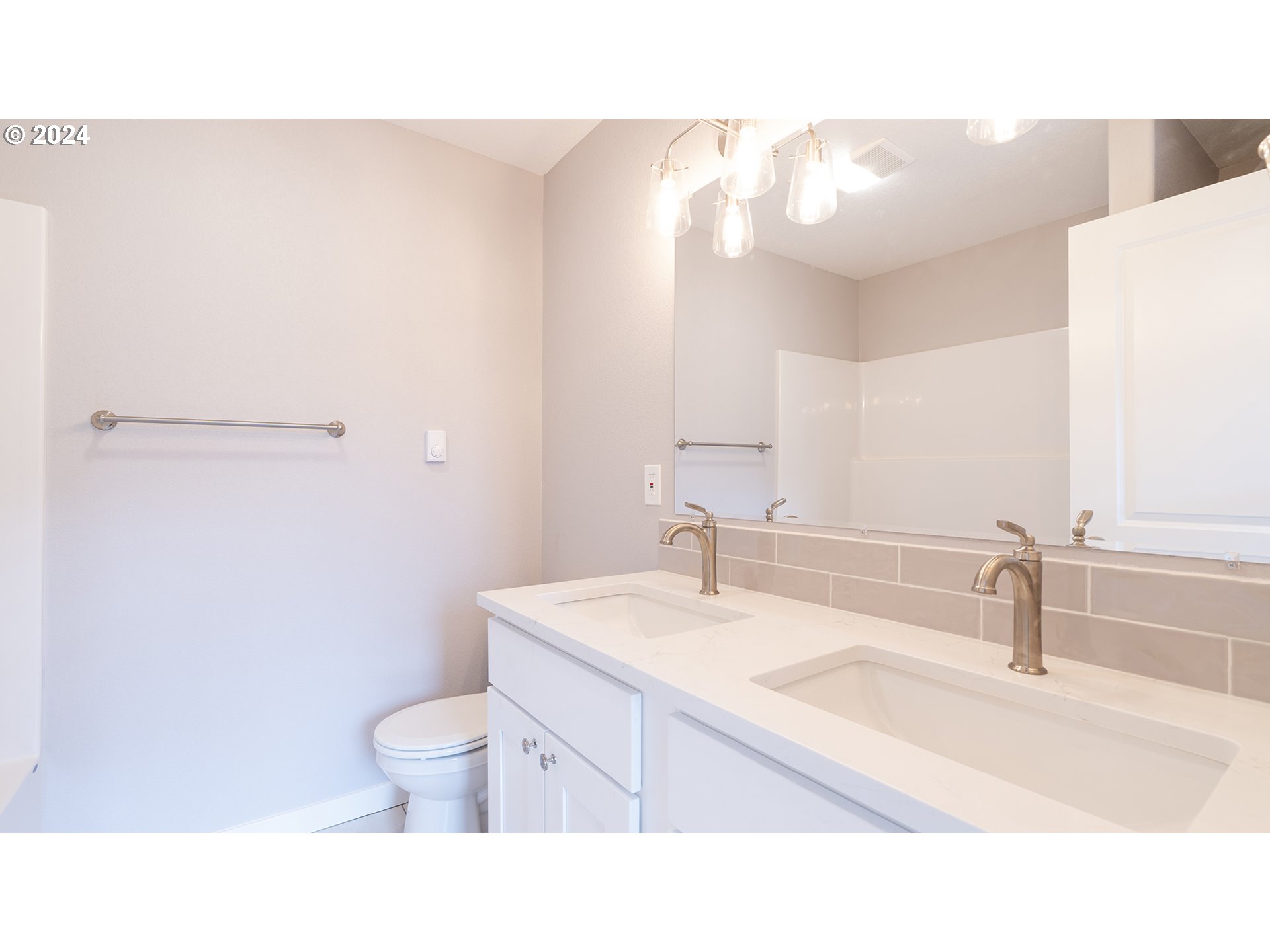 6921 Southeast Pardee Street, Unit A Portland, OR 97206 - Photo 9 of 16 a bathroom with a sink toilet a mirror and vanity