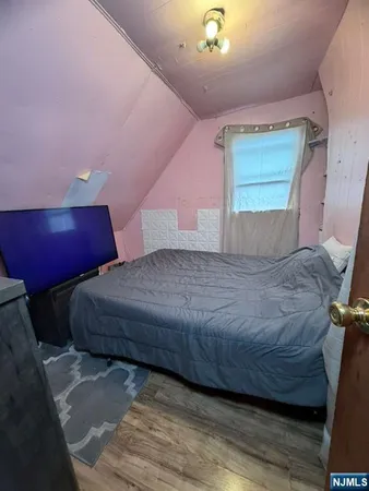 a bedroom with a bed and a night stand