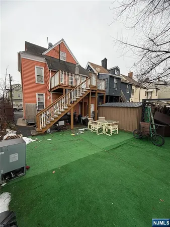 a front view of a house with a garden and deck