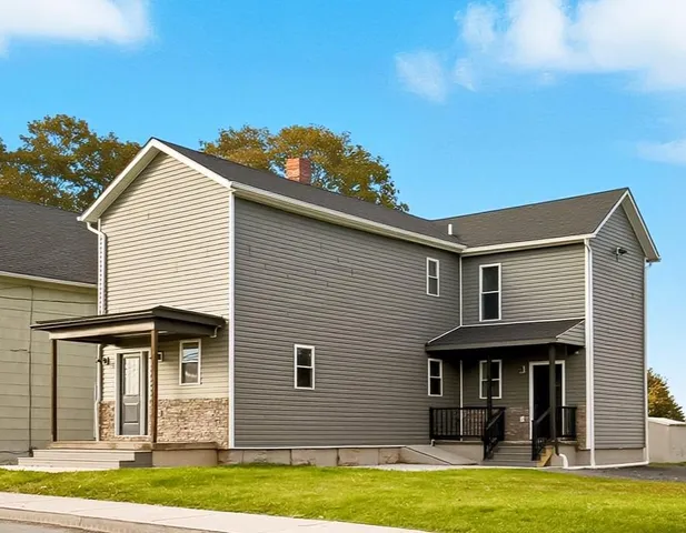 a front view of a house with a yard