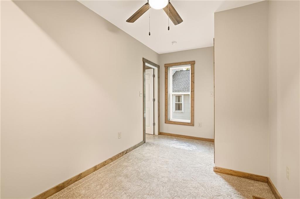 1311 Main Street Berlin, PA 15530 - Photo 15 of 36 an empty room with chandelier fan and windows