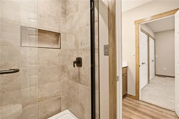 a bathroom with a shower and a glass door