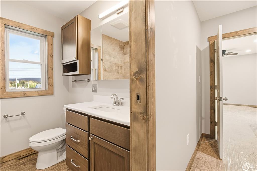 1311 Main Street Berlin, PA 15530 - Photo 21 of 36 a bathroom with a toilet a sink and a mirror