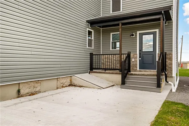 a view of a house with a small yard and wooden floor and fence