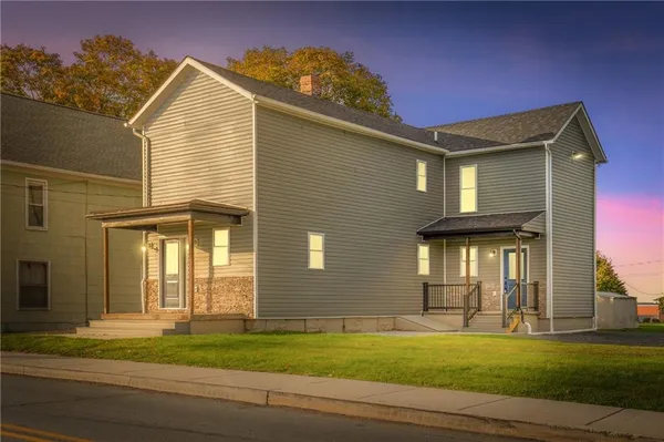 a front view of a house with a yard