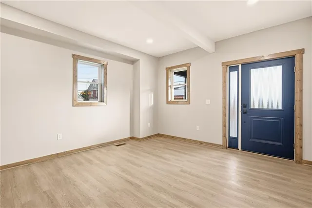 an empty room with windows and closet