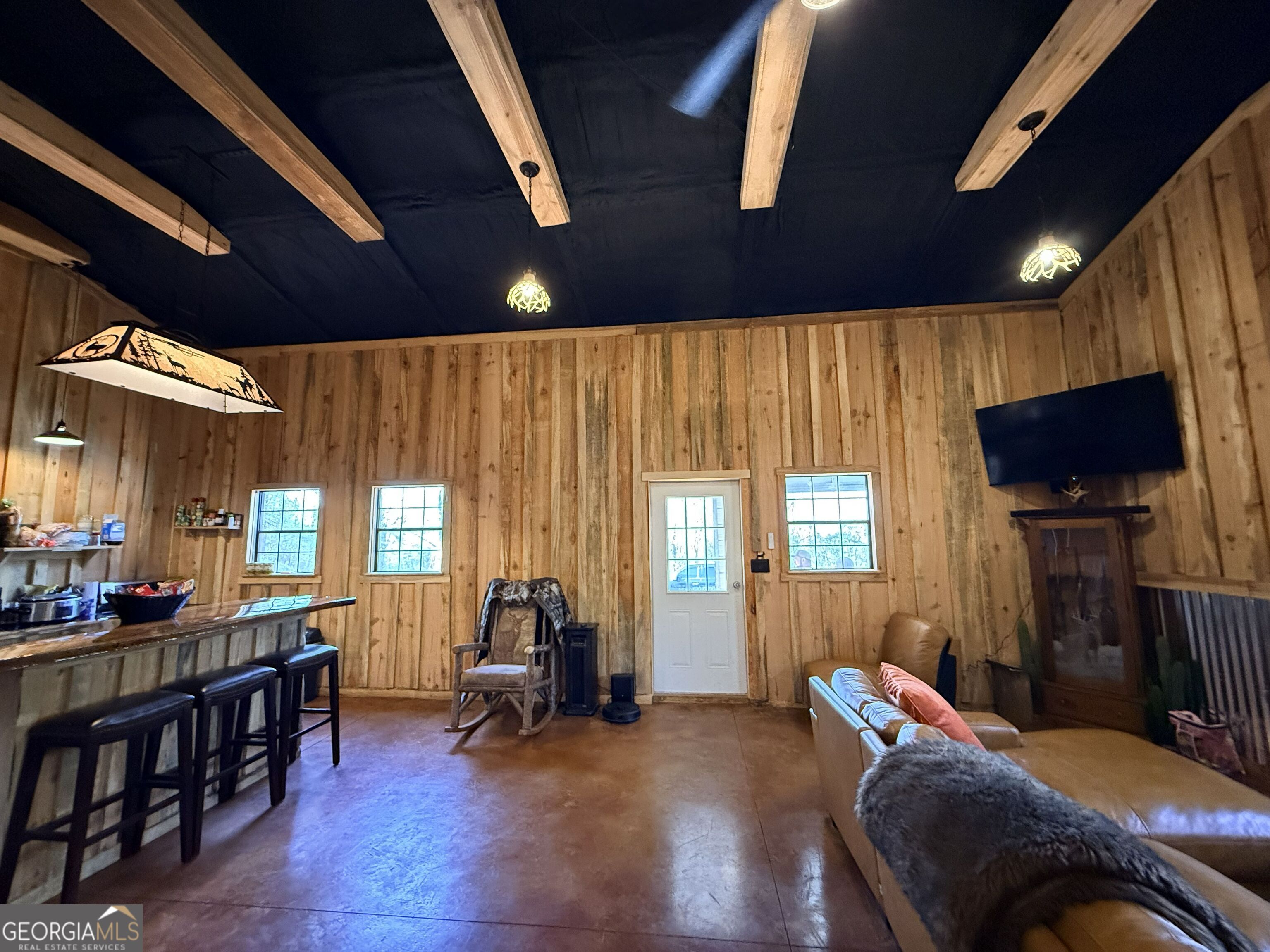 301 Beaver Dam Road Toomsboro, GA 31090 - Photo 12 of 99 a living room with furniture a window and a flat screen tv