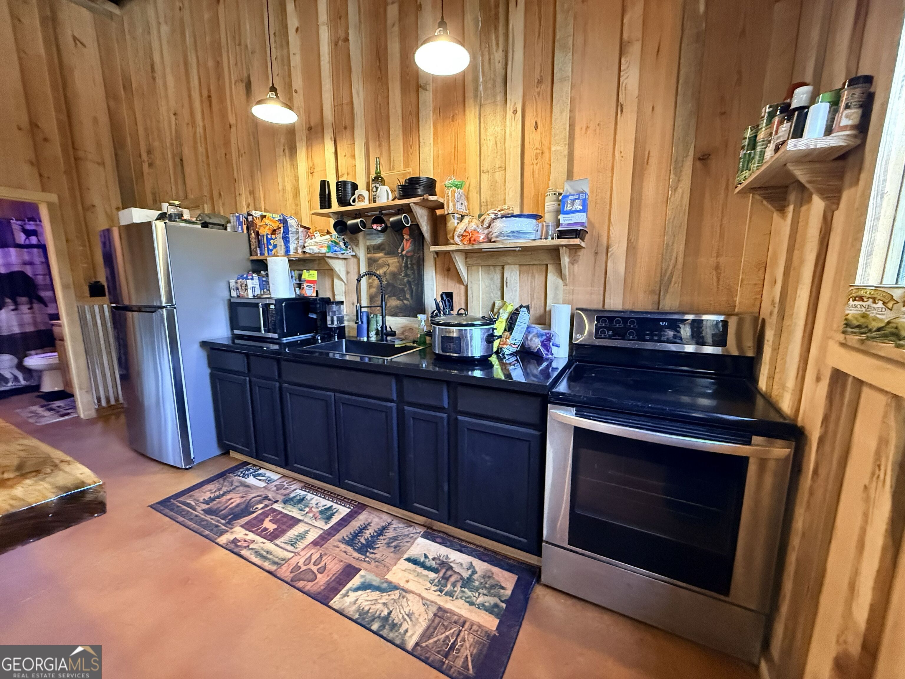 301 Beaver Dam Road Toomsboro, GA 31090 - Photo 19 of 99 a view of kitchen with stainless steel appliances wooden floor and chair