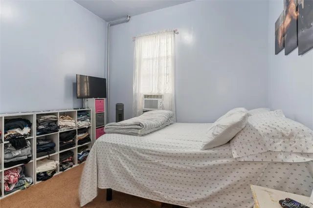 a bedroom with a bed and flat screen tv