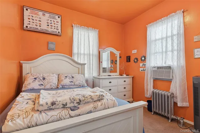 a bedroom with bed and window