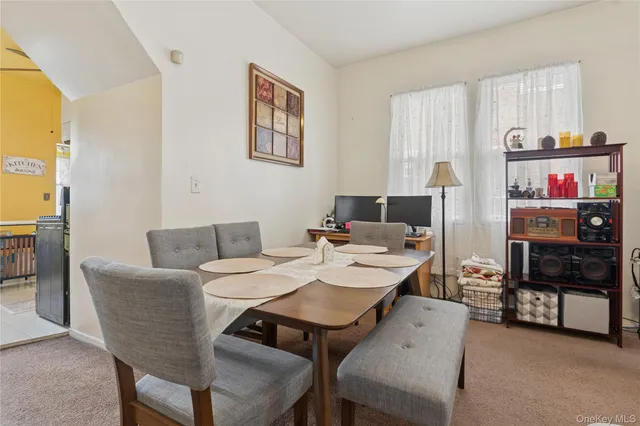 a view of a dining room with furniture and a window