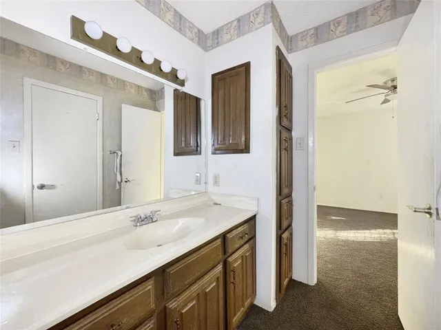 a bathroom with a sink a vanity and a mirror