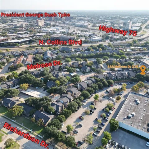 an aerial view of a house with garden space and street view