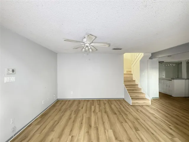 a view of a room with wooden floor and white walls