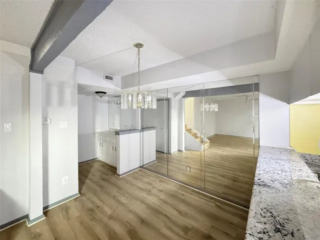 a view of a room with wooden floor and staircase