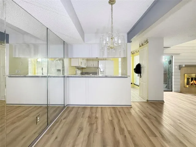 a view of a kitchen with wooden floor and windows