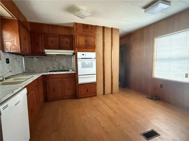 a kitchen with cabinets and a refrigerator