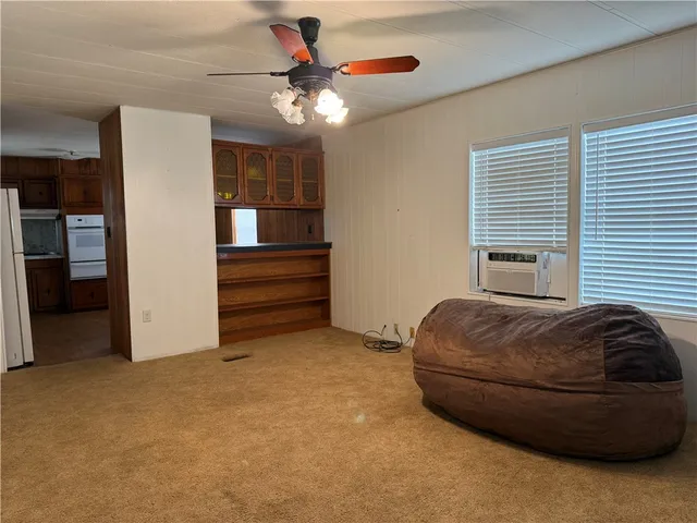 a bedroom with a bed and a ceiling fan