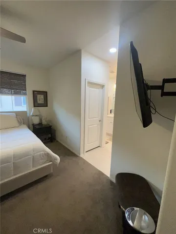 a bedroom with a bed and chair