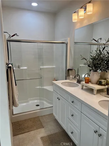 a bathroom with a granite countertop sink a toilet and shower