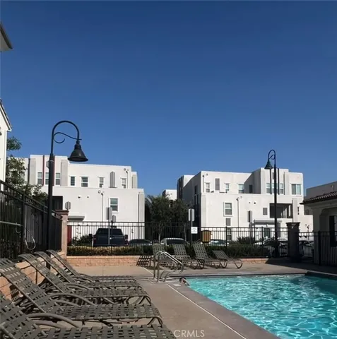 a view of a kitchen with stainless steel appliances a sink and cabinets
