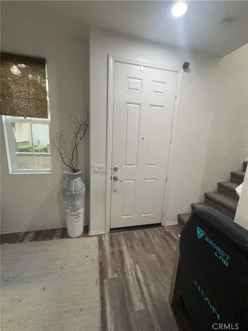 a view of empty room with windows and wardrobe