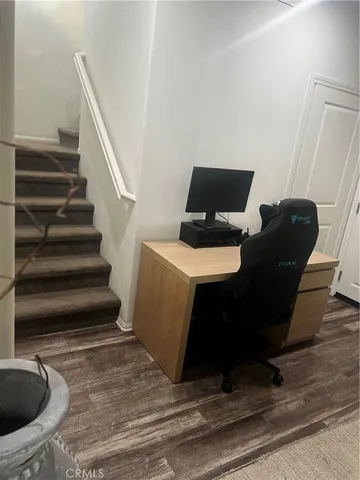 a view of a livingroom with furniture and staircase