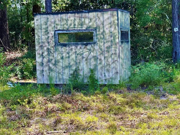 a view of garden with wooden fence