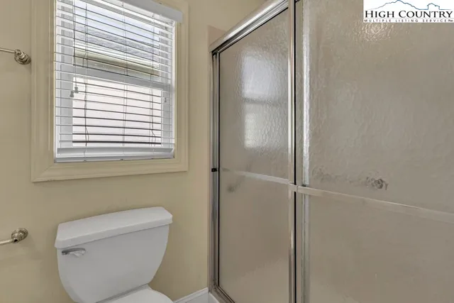 a bathroom with a toilet and a shower