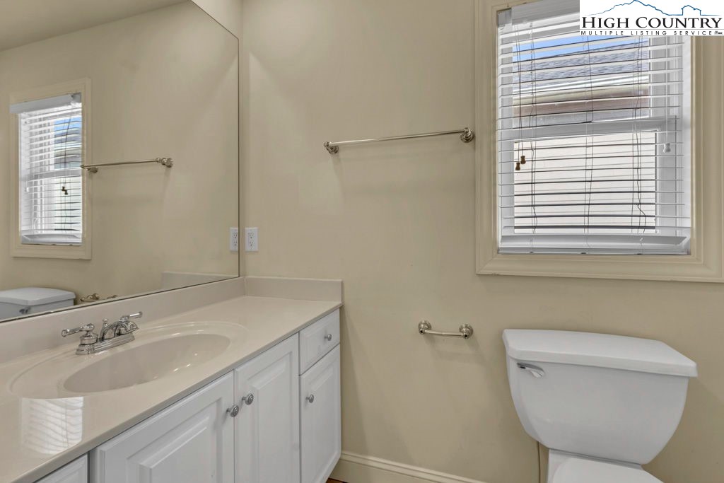 140 Silo Ridge Lane, Unit 140 Vilas, NC 28692 - Photo 15 of 27 a bathroom with a toilet sink and mirror