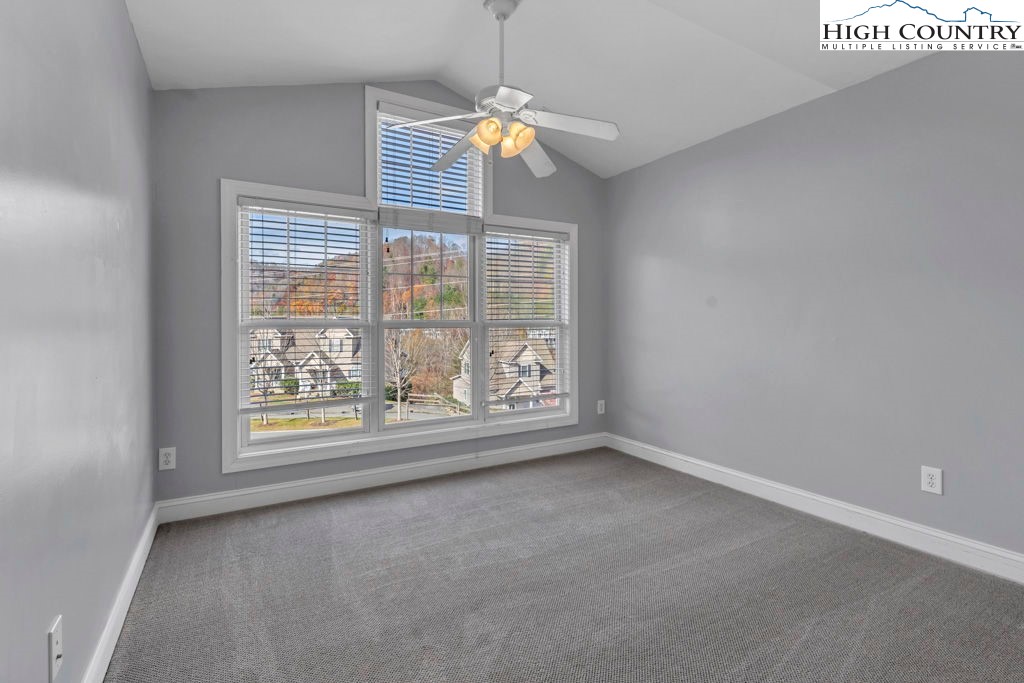 140 Silo Ridge Lane, Unit 140 Vilas, NC 28692 - Photo 17 of 27 an empty room with windows and chandelier
