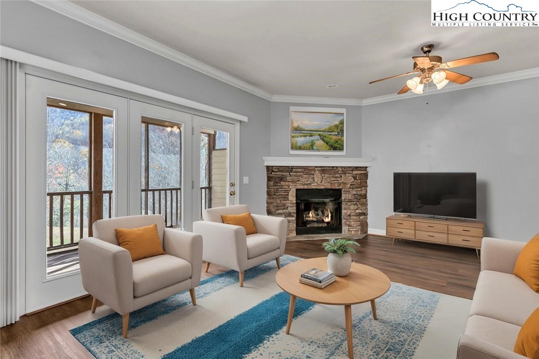 140 Silo Ridge Lane, Unit 140 Vilas, NC 28692 - Photo 2 of 27 a living room with furniture a rug a fireplace and a large window